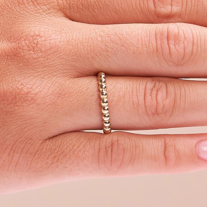 Aufnahme vom Schmuckring aus Gelbgold 585 mit Kugelmuster auf Hand