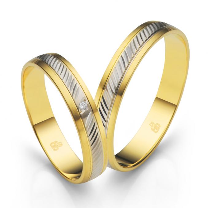 Aufnahme der längstmattierten Trauringe aus Gelbgold mit Weißgold Streifen mit Kerben und Diamanten