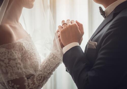 Brautpaar h&auml;lt einander an den H&auml;nden